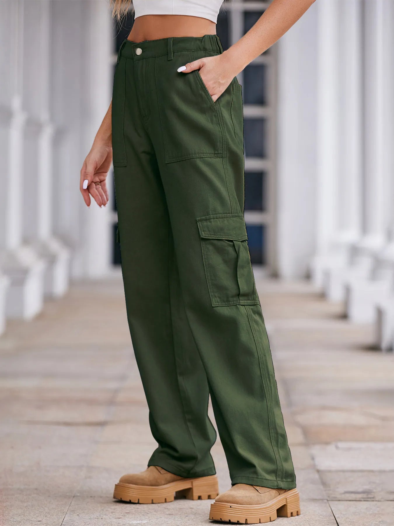 Person wearing green cargo pants with a blurred background