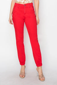 Red pants worn by a person on a white background