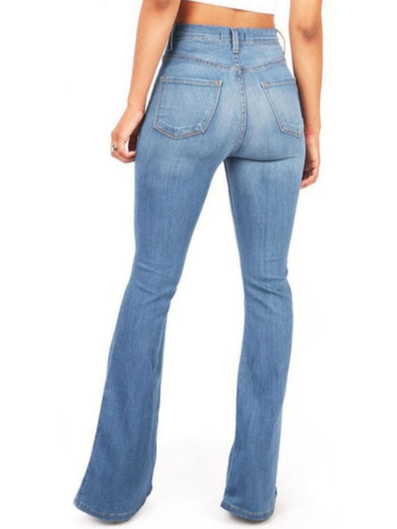 Blue flared jeans worn by a person on a white background