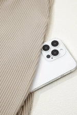 Close-up of a smartphone with a beige textured fabric background