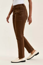 Brown pants worn by a person on a light beige background