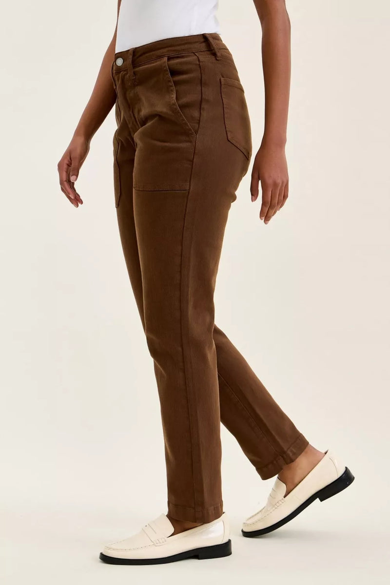 Brown pants worn by a person on a light beige background