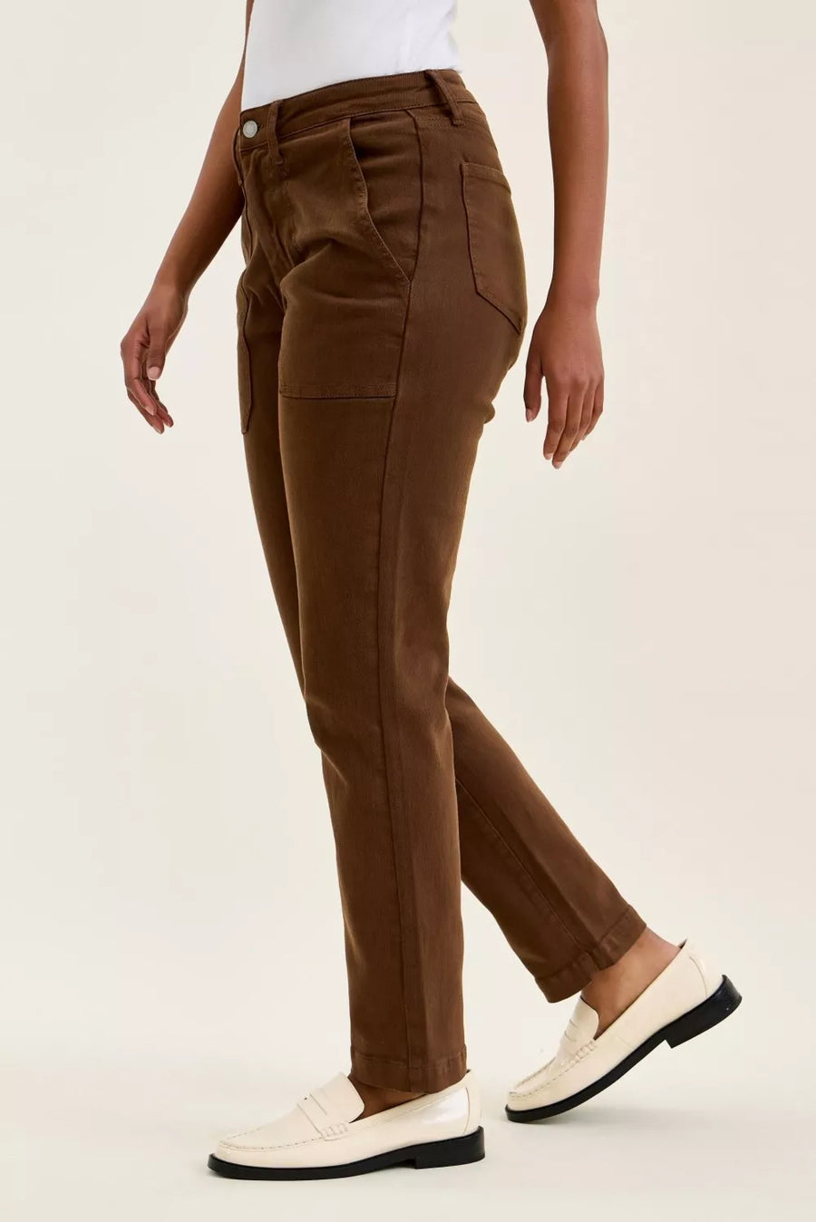 Brown pants worn by a person on a light beige background