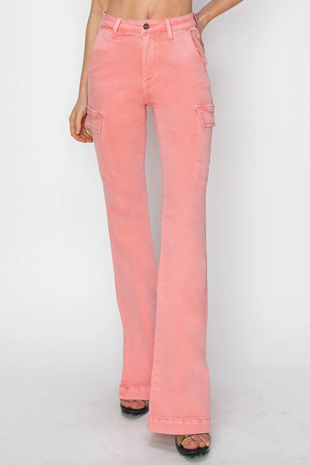 Pink flared jeans worn by a person on a white background