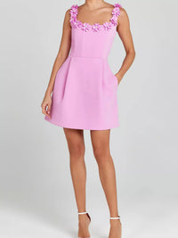 Pink dress with floral straps on a white background