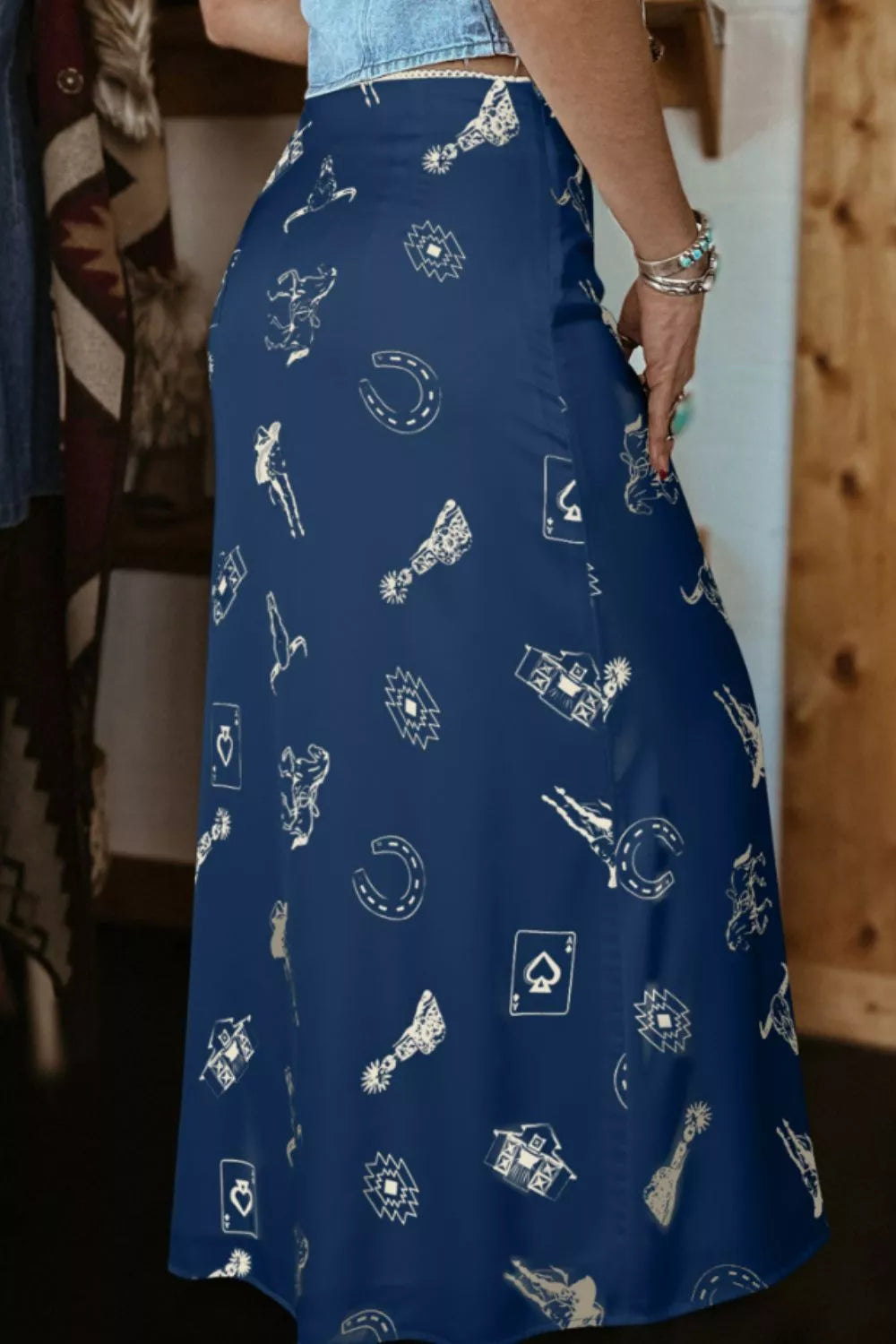 Person wearing a blue skirt with white patterns indoors.