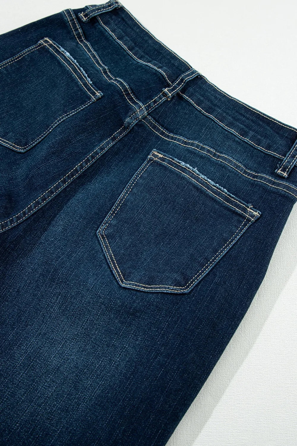 Close-up of blue denim jeans on a white background