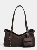 Brown handbag with a shoulder strap on a white background
