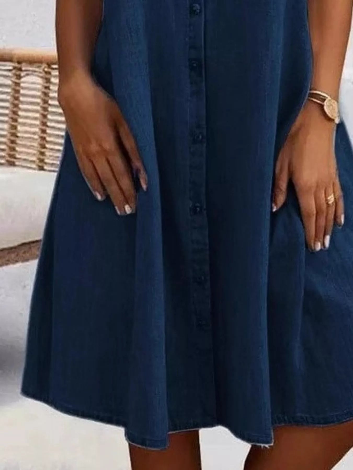 Navy blue dress worn by a person with a blurred background