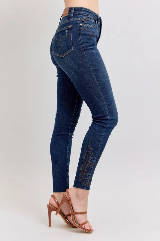 Blue jeans worn by a person on a white background
