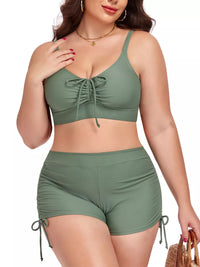 Woman wearing a green bikini set on a white background