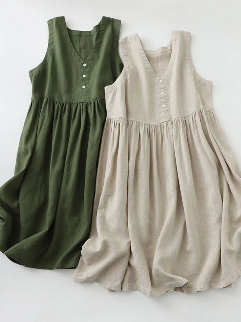Two sleeveless dresses, one green and one beige, on a white background