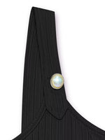 Black garment with a pearl button on a white background