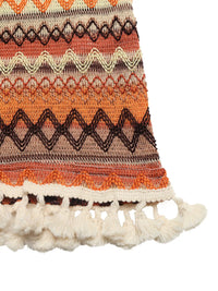 Textile with orange, brown, and beige pattern on a white background