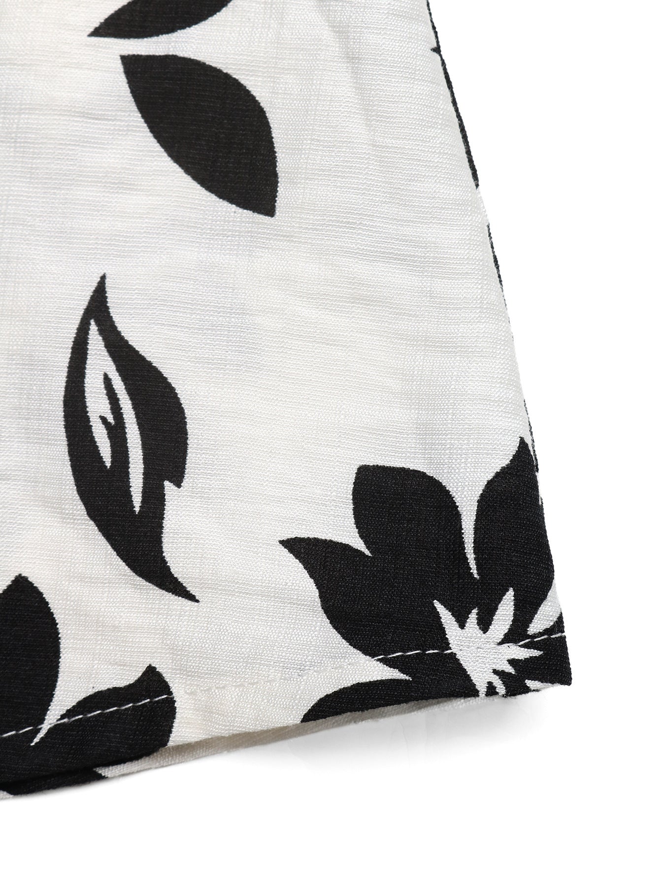 Close-up of a white fabric with black leaf pattern