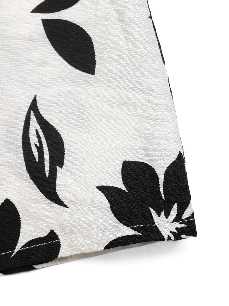 Close-up of a white fabric with black leaf pattern