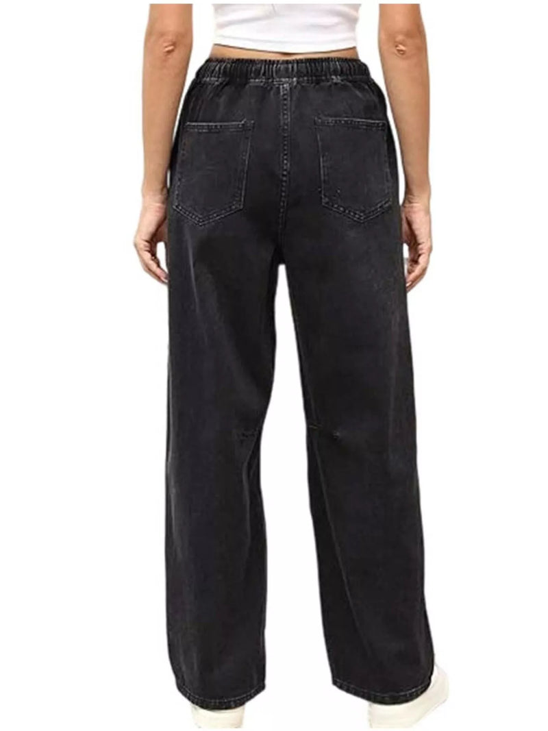 Black wide-leg jeans worn by a person on a white background