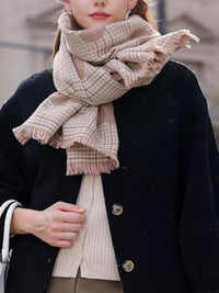 Person wearing a plaid scarf with a blurred background