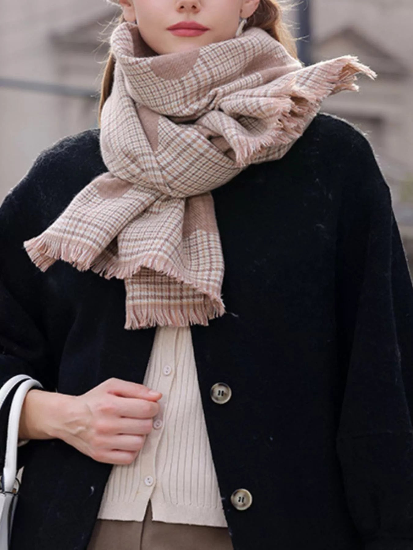 Person wearing a plaid scarf with a blurred background