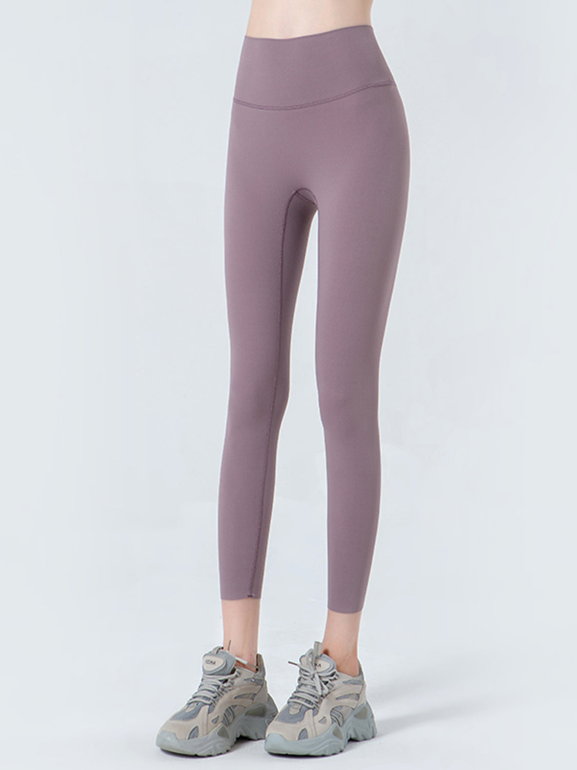 Purple leggings worn by a person on a white background