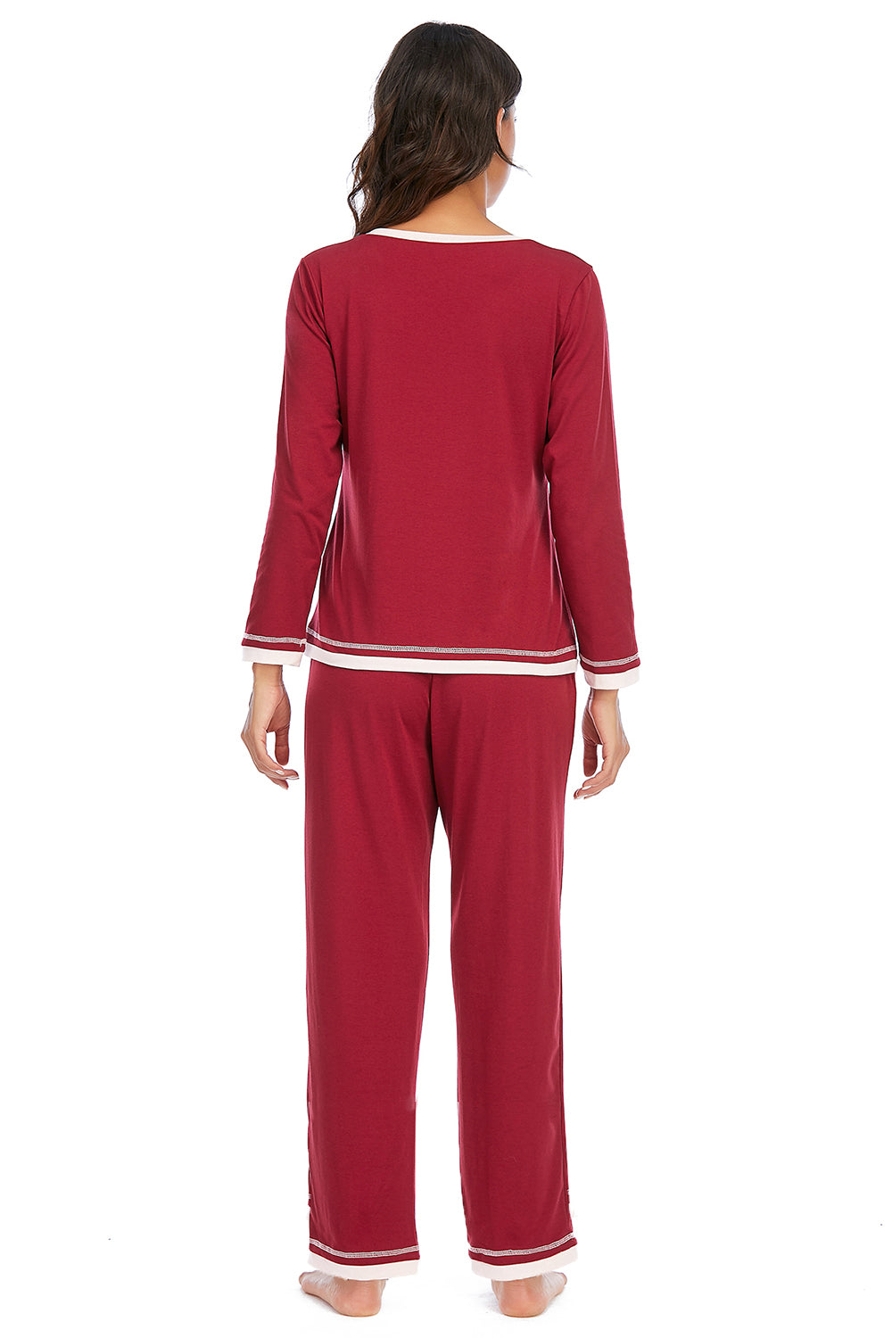 Red pajama set with white trim worn by a person on a white background
