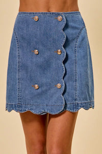 Blue denim skirt with button details on a beige background