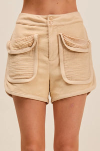 Beige shorts with large pockets on a beige background