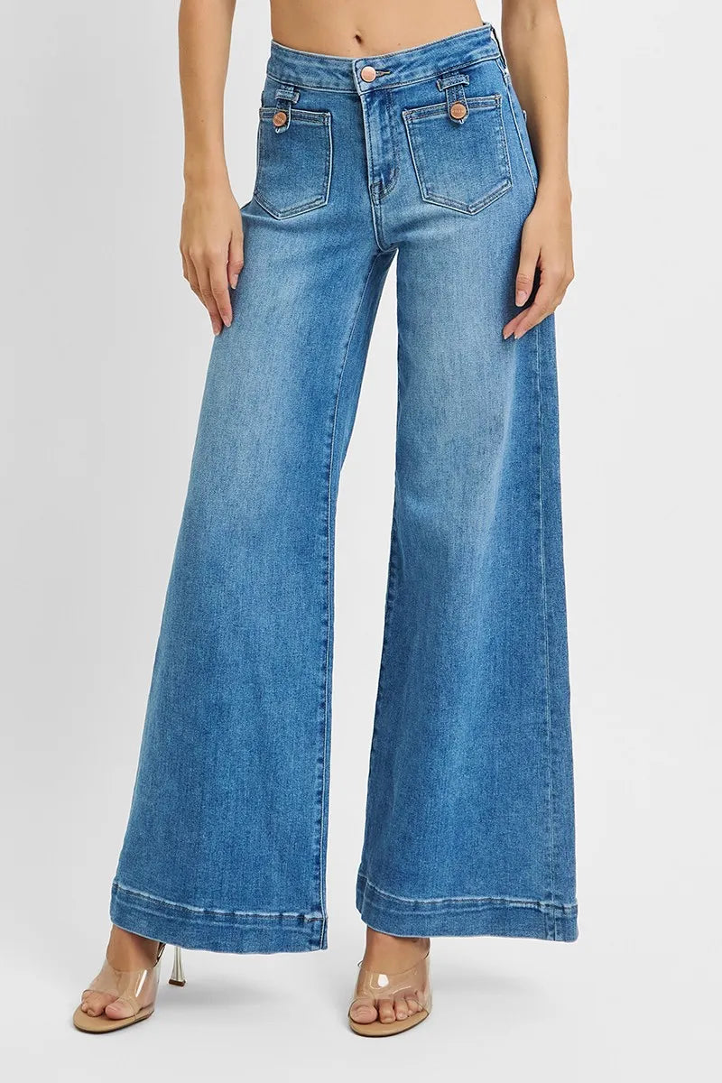 Blue jeans worn by a person on a white background