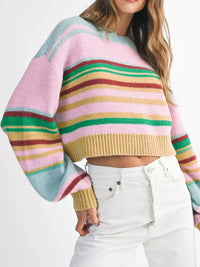 Multicolored striped sweater worn by a person on a white background