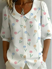White blouse with floral pattern worn by a person