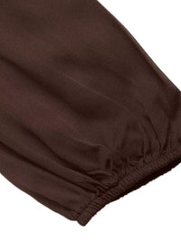 Close-up of brown pants with a white background