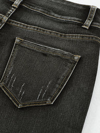 Close-up of a black denim pocket on jeans.