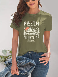 Person wearing a green t-shirt with 'Faith can move mountains' design.