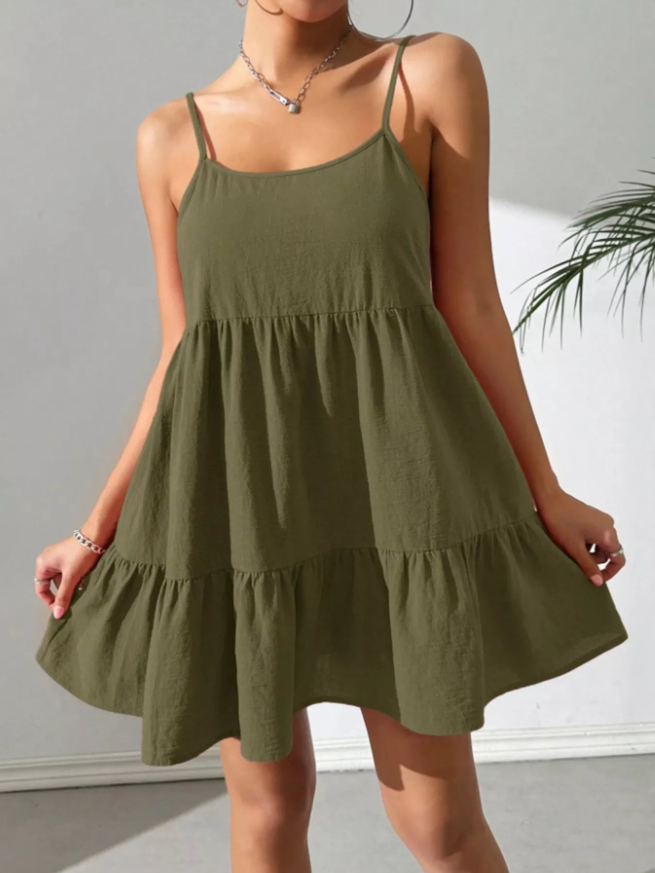 Woman wearing a green dress against a neutral background