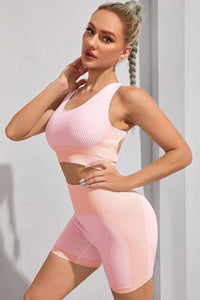 Woman wearing a pink athletic outfit against a plain background