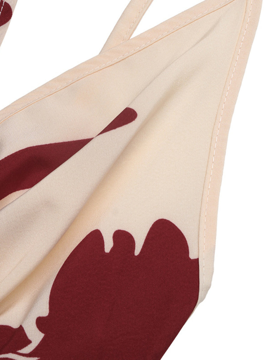 Beige bikini top with red abstract design on a white background