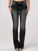 Black jeans worn by a person on a white background