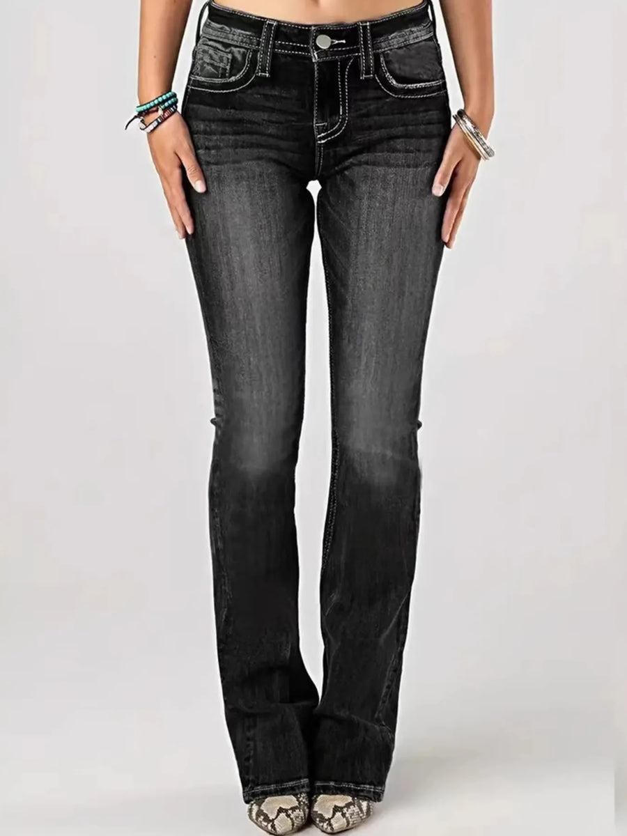 Black jeans worn by a person on a white background