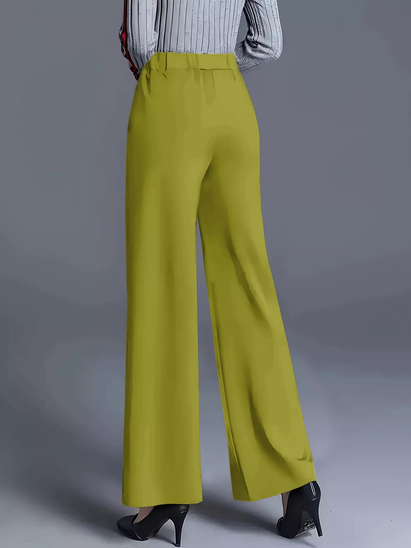 Yellow wide-leg pants worn by a person on a gray background