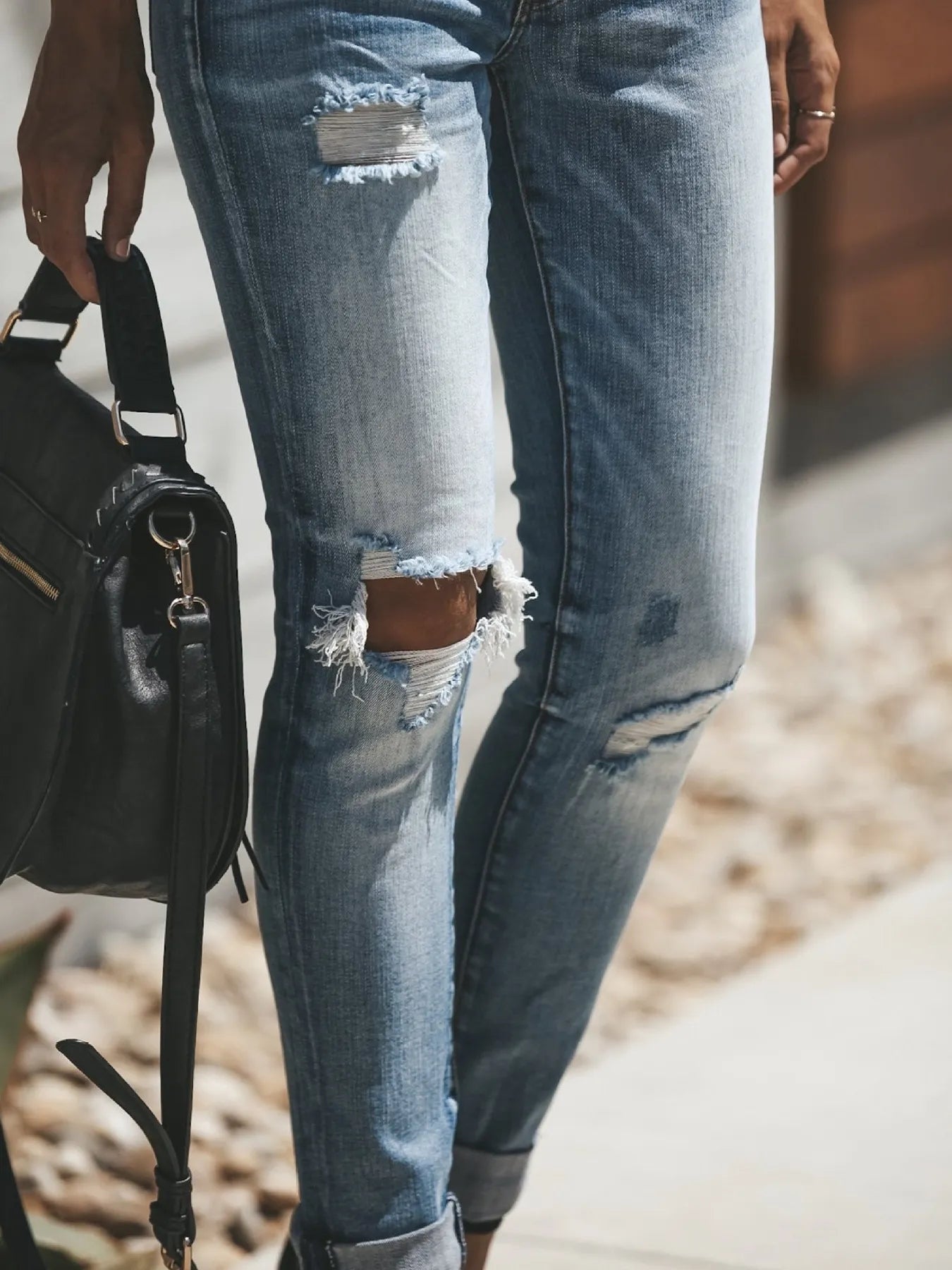 Close-up of distressed blue jeans with a blurred background