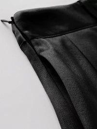 Close-up of a black textured fabric on a light gray background