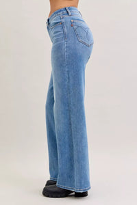 Light blue jeans worn by a person on a white background