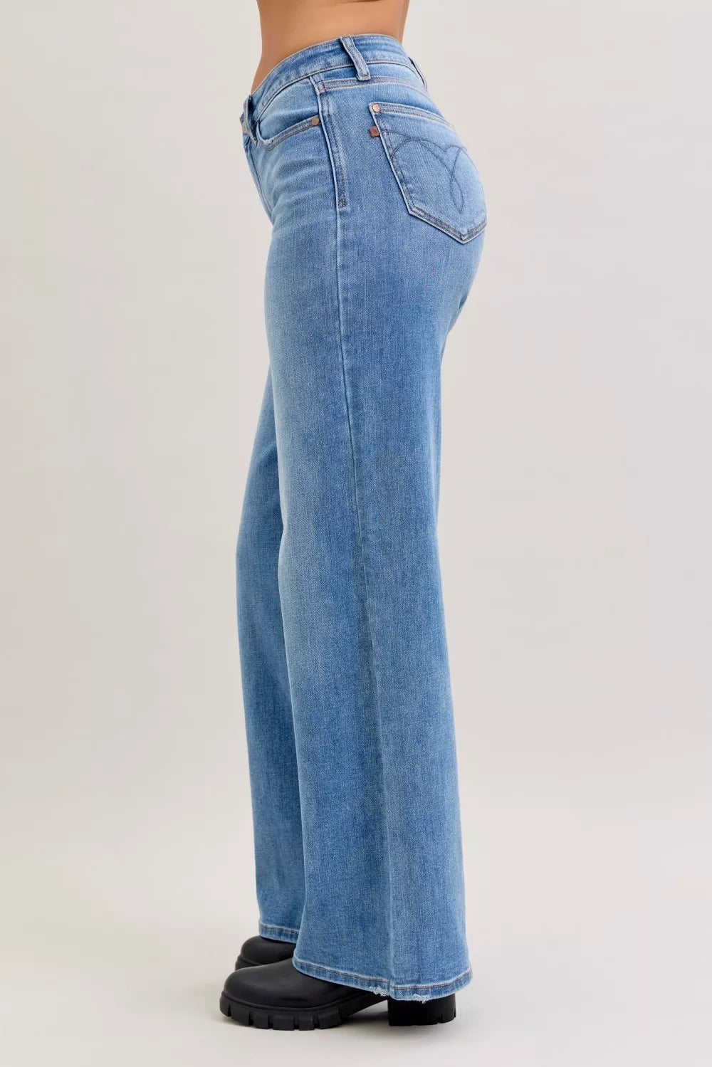 Light blue jeans worn by a person on a white background