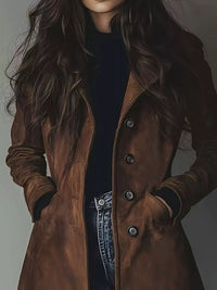 Person wearing a brown leather coat with a plain background