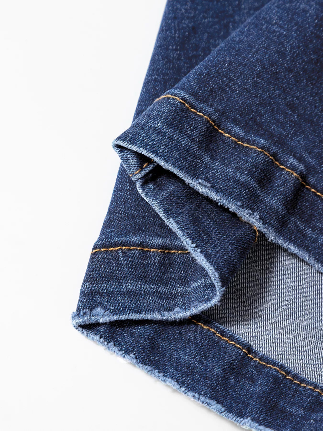 Close-up of blue denim fabric with a white background