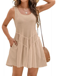 Woman wearing a beige sleeveless dress with a white background