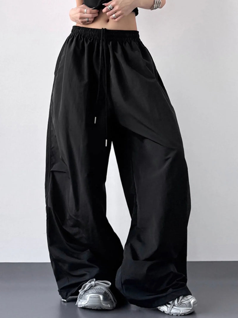 Black wide-leg pants worn by a person on a plain background