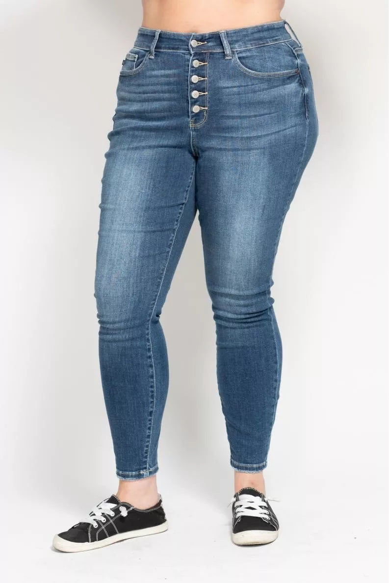 Blue jeans worn by a person on a white background