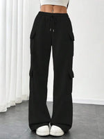 Black cargo pants worn by a person on a white background