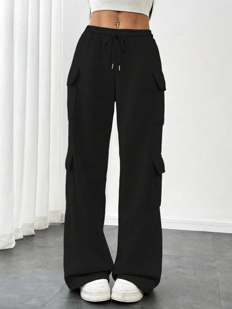 Black cargo pants worn by a person on a white background